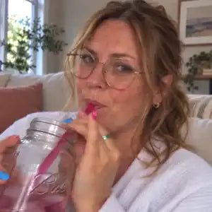 AI-edited lifestyle portrait sipping iced tea from a mason jar